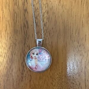 Elsa Silver Pendant Necklace with Pink and Blue Background.